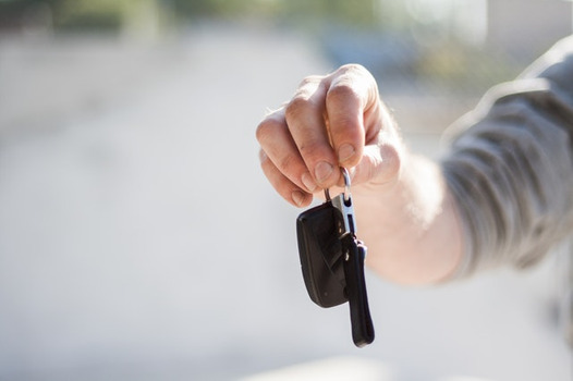 Car keys get handed to owner on auto shipping delivery